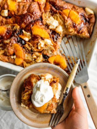 holding a bowl of Peaches and Cream Bread Pudding