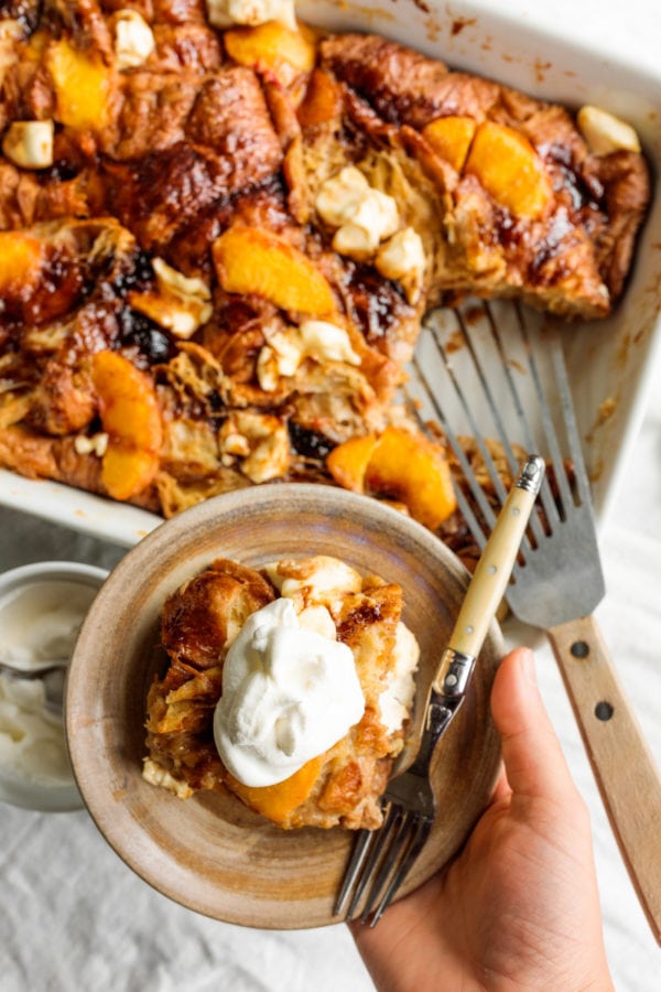 holding a bowl of Peaches and Cream Bread Pudding