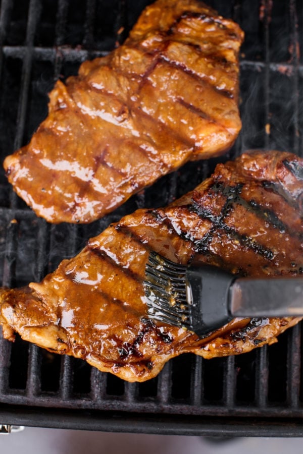 brushing marinade on NY steak