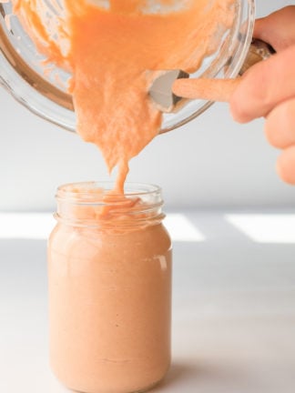 scraping rhubarb curd into a jar