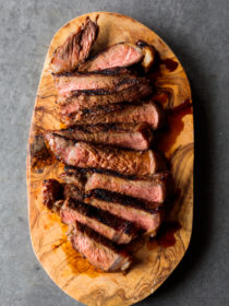 slices of Miso Marinated New York Steak on wood plate