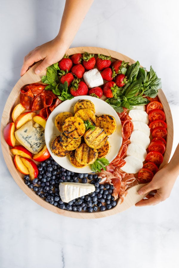 holding a Grilled Polenta Appetizer Board