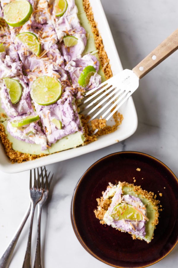 taking a piece of Key Lime Coconut Cheesecake Bars