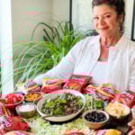 a woman holding an Epic Walking Taco Board
