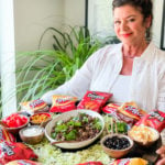 a woman holding an Epic Walking Taco Board