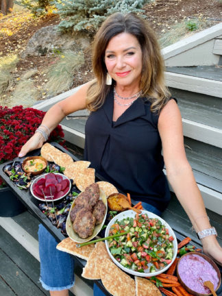 woman holding a pita burger board