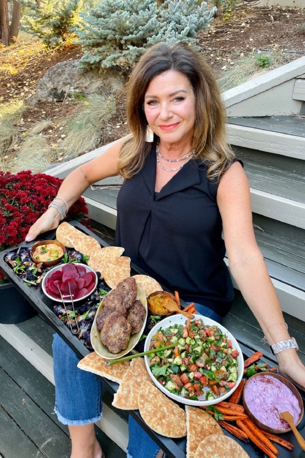 woman holding a pita burger board