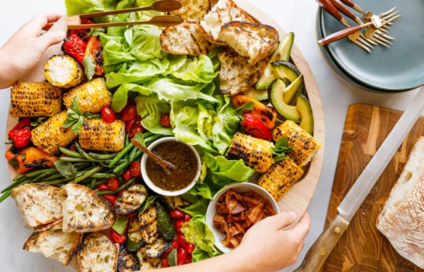 setting down a Grilled BLT Salad Board