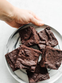 holding a plate of Mocha Orange Brownies