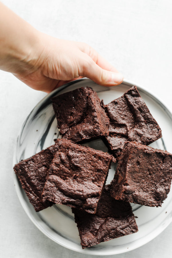 holding a plate of Mocha Orange Brownies