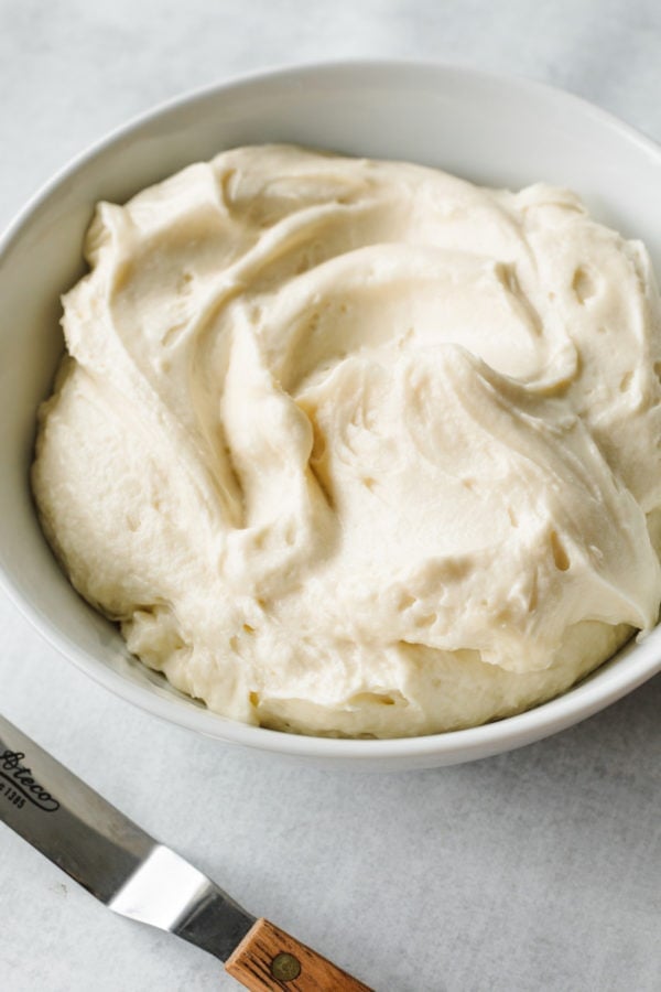 white bowl of fluffy Cream Cheese Mascarpone Frosting