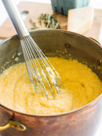 whisking a pot of Cheesy Garlic Polenta Recipe