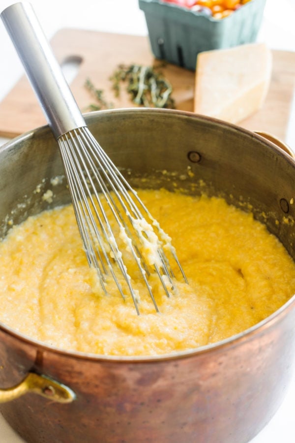 whisking a pot of Cheesy Garlic Polenta Recipe