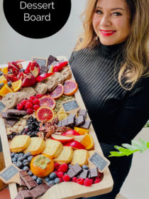 woman holding a dessert board with dark chocolate