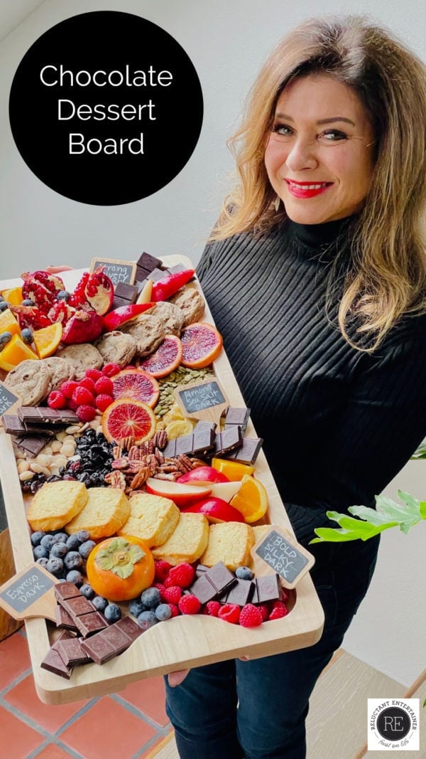 woman holding a dessert board with dark chocolate