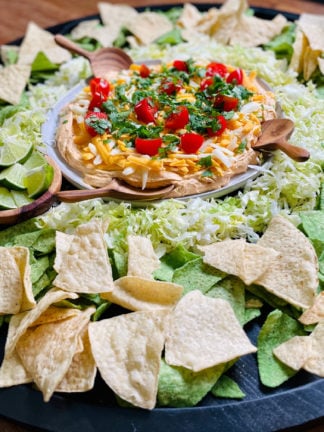 chips on a board with taco dip