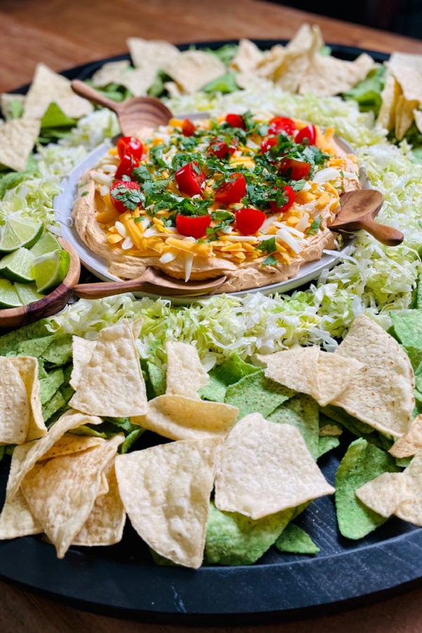 chips on a board with taco dip