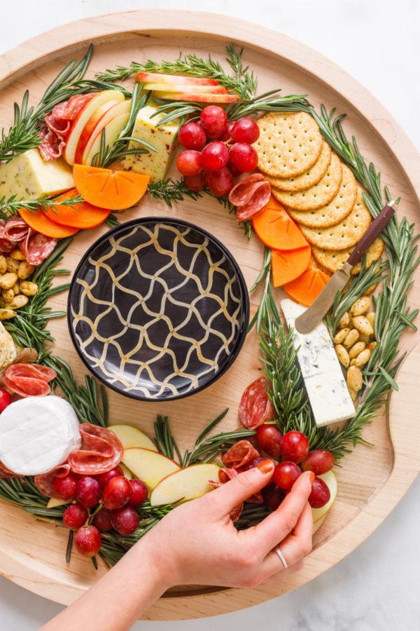 Christmas Wreath Charcuterie Board with black dishes in the center