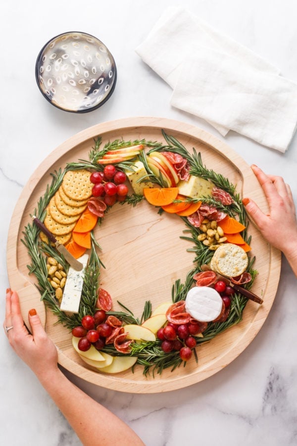 holding a Christmas Wreath Charcuterie Board