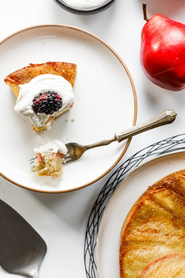 taking a bite of Almond Pear Upside Down Cake