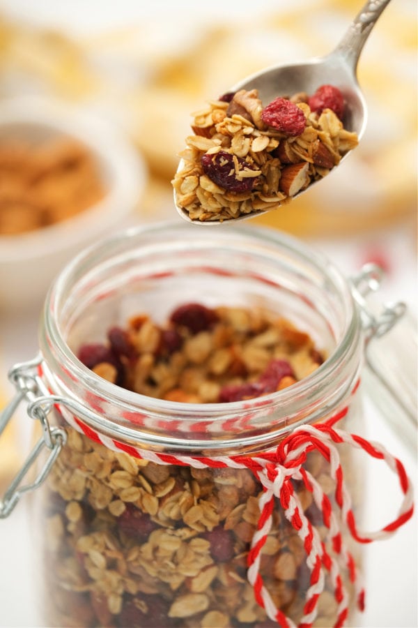 taking a spoonful of homemade coconut granola