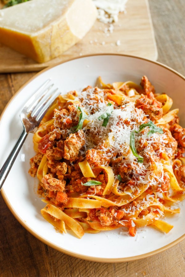 a serving of Healthy Ground Chicken Pasta with Parmesan cheese and fresh basil
