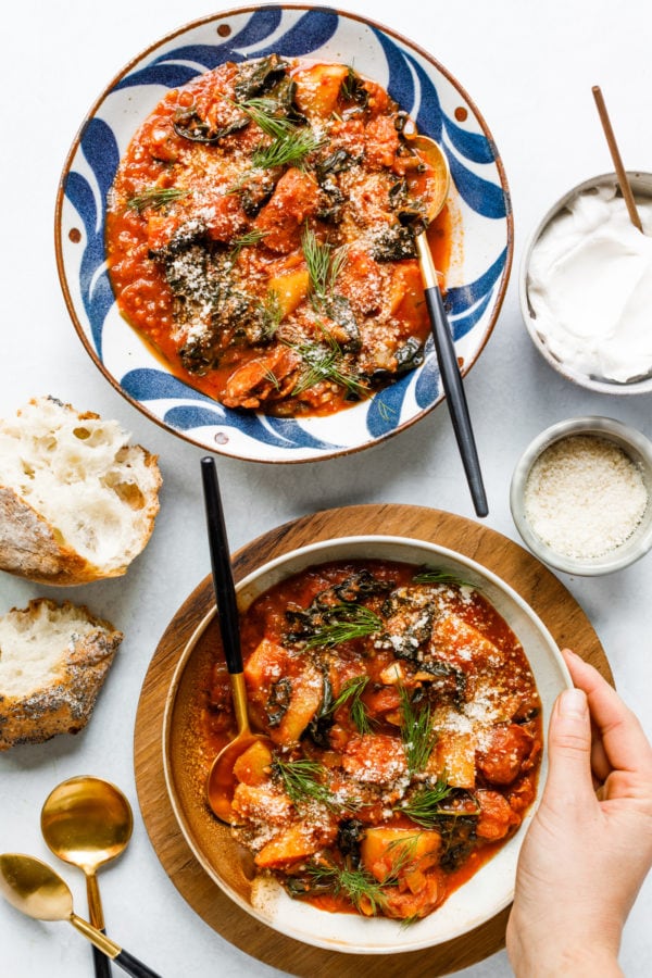 hand on a bowl of Sausage Bacon Tomato Soup