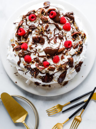 a Maple Pecan Chocolate Pavlova cake with serving utensils