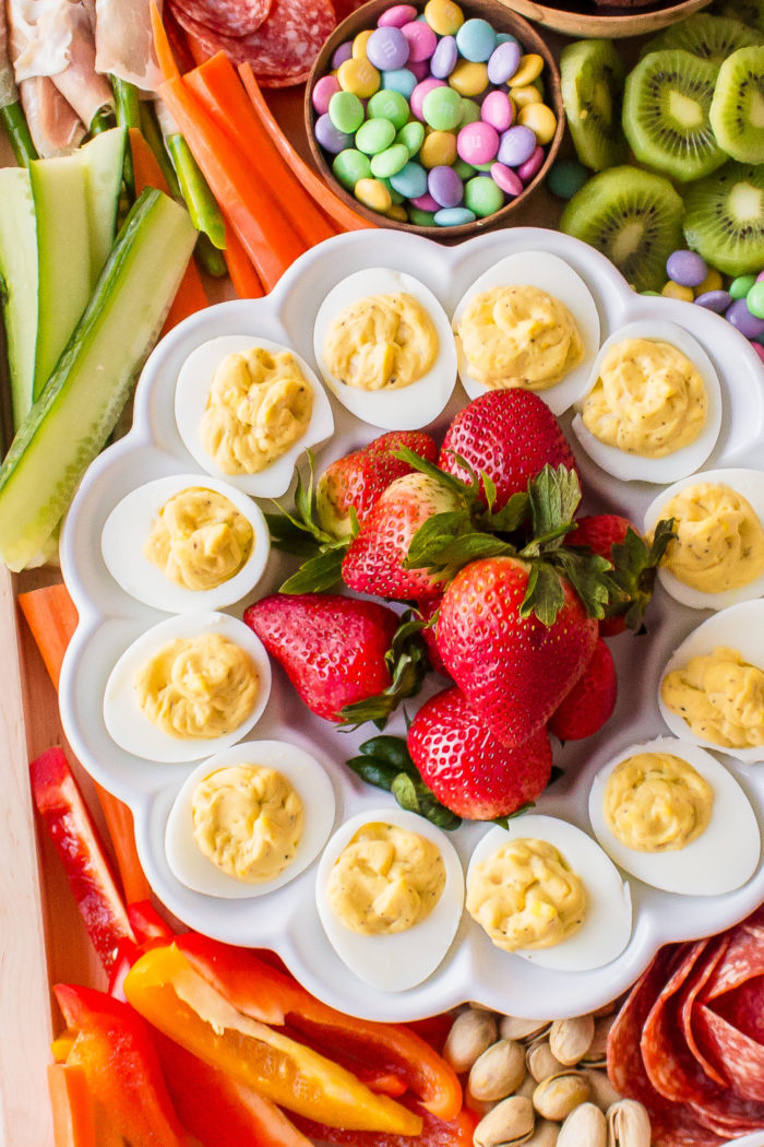deviled eggs on platter with strawberries