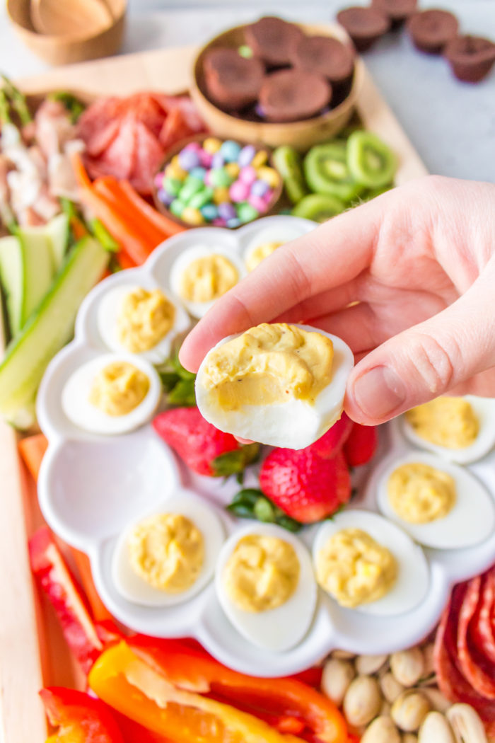 taking a bite of deviled egg