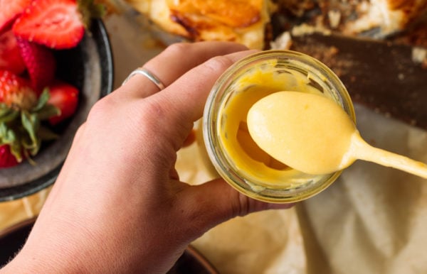 taking a spoonful of mango orange curd