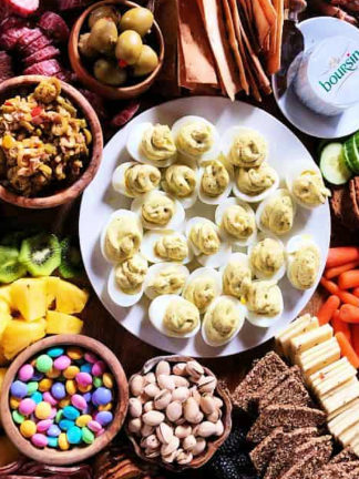 deviled eggs in the center of a Easter snack board