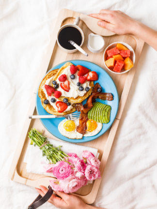 breakfast board in bed with coffee