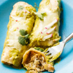 white pan of Cheesy Seafood Green Enchiladas