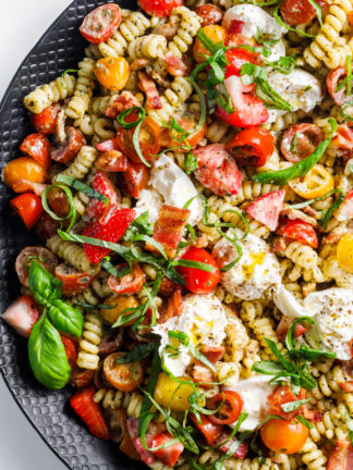 Creamy Caprese Pasta Salad in black serving platter