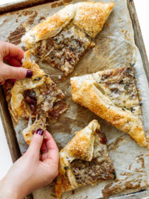 taking a cheesy bite of Fig and Gruyere Puff Pastry Tart