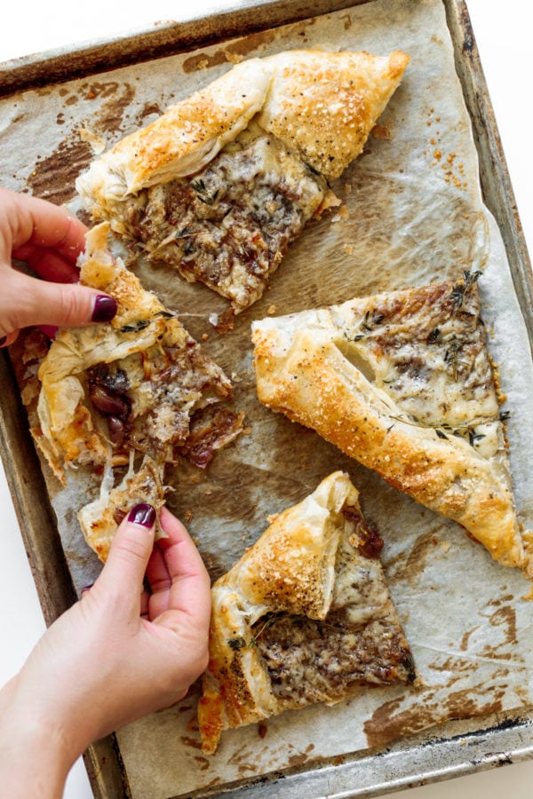 taking a cheesy bite of Fig and Gruyere Puff Pastry Tart