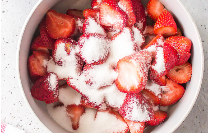mixing sugar with strawberries