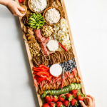 taking a bite of Summer Snack Board