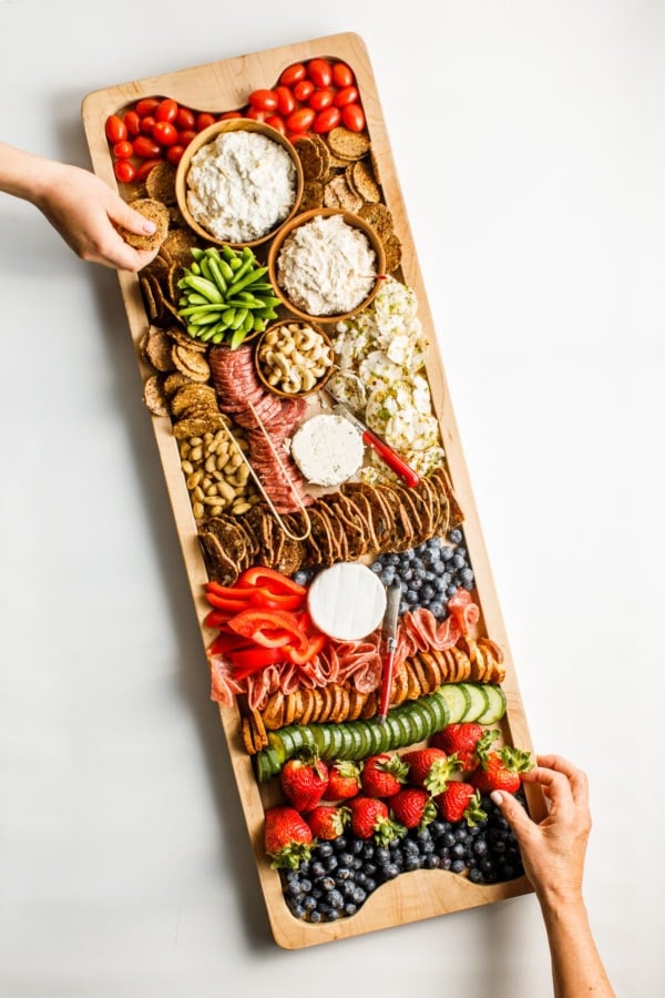 taking a bite of Summer Snack Board