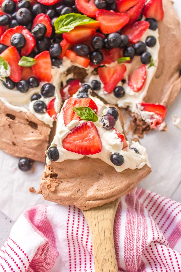 a pie serving of Strawberry Blueberry Chocolate Pavlova