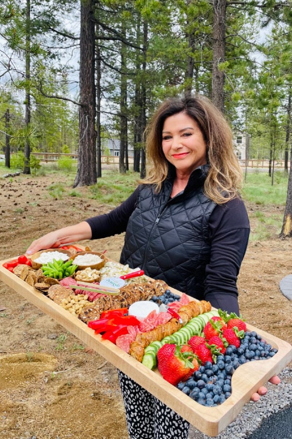woman holding a Summer Snack Board