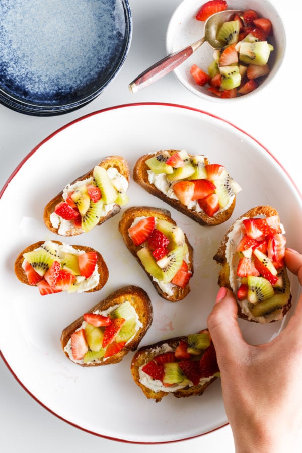 taking a bite of Strawberry Kiwi Crostini Bites