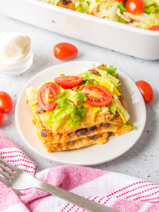 serving on a plate of Layered Enchilada Bake