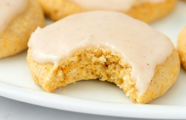 taking a bite of pumpkin cookie