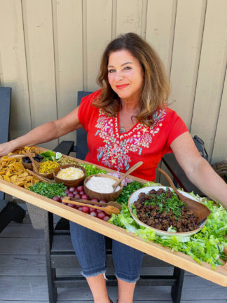 woman holding a Taco Salad Board