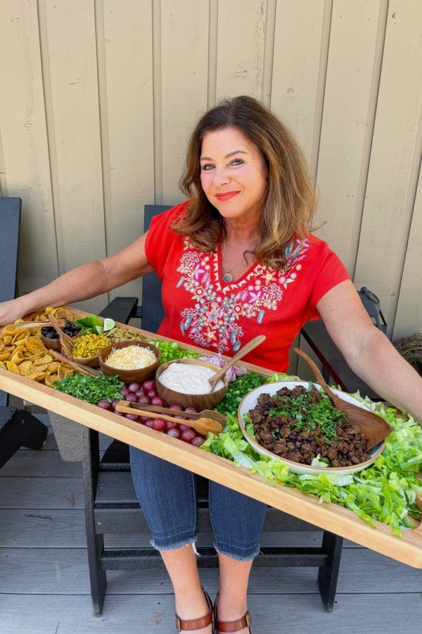 woman holding a Taco Salad Board