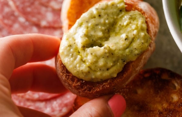 Pesto White Bean Dip spread on crostini