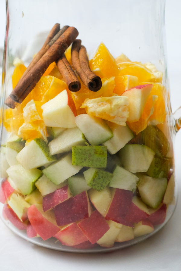 fruit in pitcher with cinnamon sticks