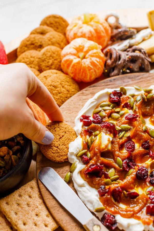 ginger snap cookie in pumpkin dip